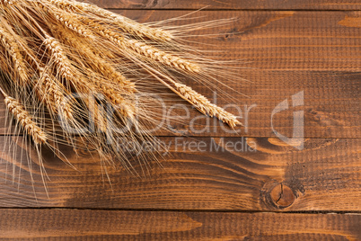 Wheat on wooden background