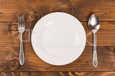 spoon and fork on a plate on the table
