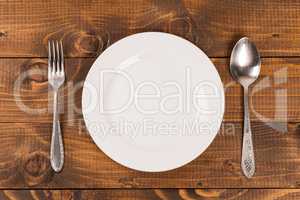 spoon and fork on a plate on the table