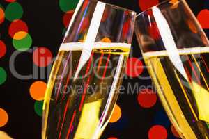 Two champagne glass on christmas bokeh background
