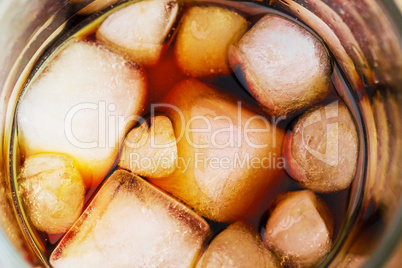 Cola in glass with ice from top