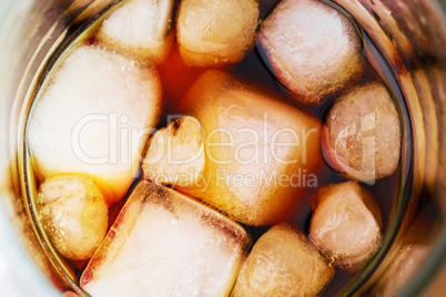 Cola in glass with ice from top