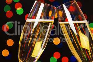 Two champagne glass on christmas bokeh background