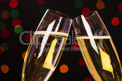 Two champagne glass on christmas bokeh background