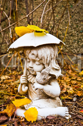 Profile of Young Girl Holding Umbrella and Bird Statue