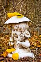 Profile of Young Girl Holding Umbrella and Bird Statue
