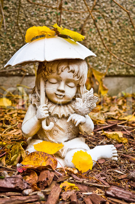 Young Girl Holding Umbrella and Bird Statue