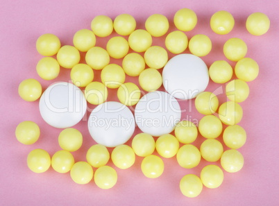 yellow vitamins on pink background