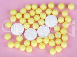 yellow vitamins on pink background