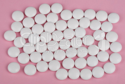 white pill on pink background