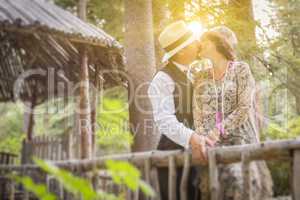 1920s Dressed Romantic Couple Kissing on Wooden Bridge