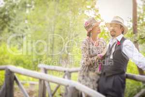 1920s Dressed Romantic Couple on Wooden Bridge