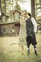 1920s Dressed Romantic Couple in Front of Old Cabin