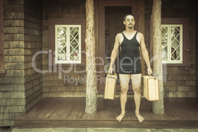 Gentleman Dressed in 1920?s Era Swimsuit Holding Suitcases on