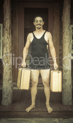 Gentleman Dressed in 1920?s Era Swimsuit Holding Suitcases on