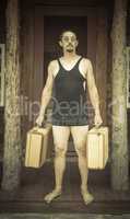 Gentleman Dressed in 1920?s Era Swimsuit Holding Suitcases on