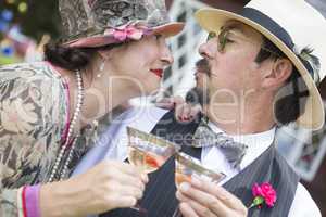 Mixed-Race Couple Dressed in 1920?s Era Fashion Sipping Champa