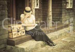 Distressed 1920s Girl Near Suitcases on Porch with Vintage Effec