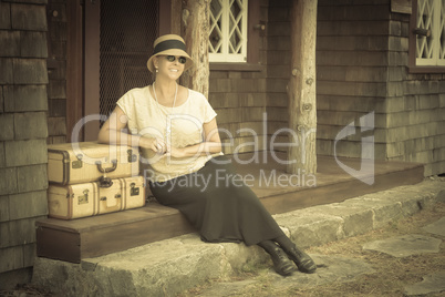 1920s Dressed Girl and Suitcases on Porch with Vintage Effect