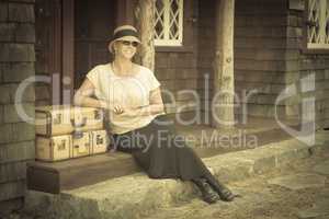 1920s Dressed Girl and Suitcases on Porch with Vintage Effect