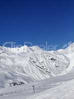 Ski slope and ropeway at nice sun day