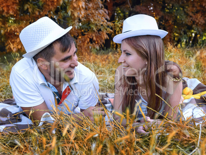 happy young couple relaxing in the park on the grass