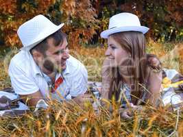 happy young couple relaxing in the park on the grass