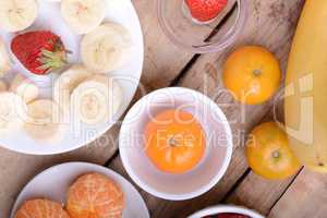 Fresh colorful fruits composition mandarin, strawberry, peach, bananas and orange