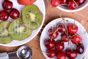 fruit with cherry, strawberry, kiwi on wooden plate