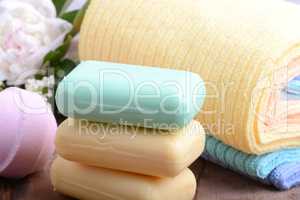 towels set, aroma therapy, soap and sea salt on wooden plate