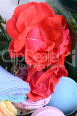 Spa and wellness setting with sea salt, oil essence, flowers and towels on wooden background. Relax and treatment therapy. Summer season. Close up