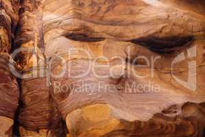 Red striped rock texture in Wadi Mujib canyon in Jordan