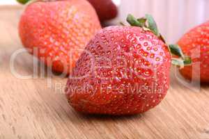 Strawberry set on wooden plate close up