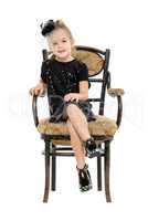 Little Girl Sitting in Antique Chair