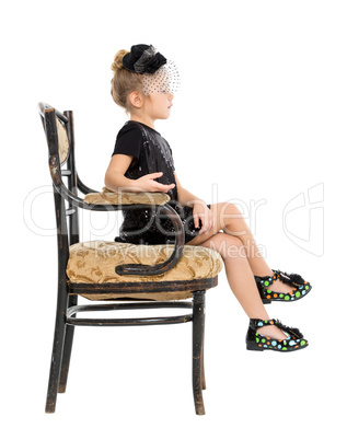 Little Girl Sitting in Antique Chair