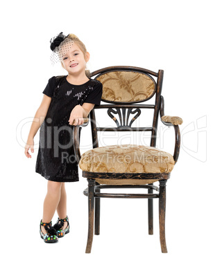 Little Girl Standing near Antique Chair