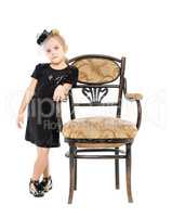 Little Girl Standing near Antique Chair