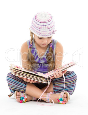 Little Girl Looking Album Sitting on the Floor