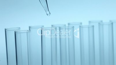 Liquid dripping from pipette into test tube