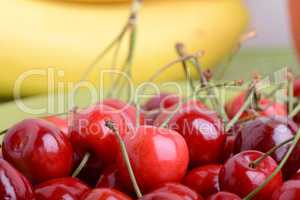 Close up of a fresh pile of fruit consisting of cherries and bananas