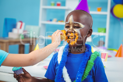 Smiling kid with icing on his face
