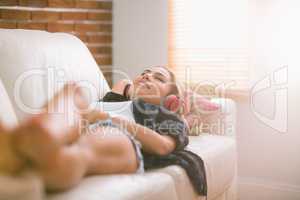 Pretty blonde relaxing on the couch listening to music