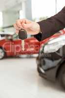 Saleswoman holding a car key