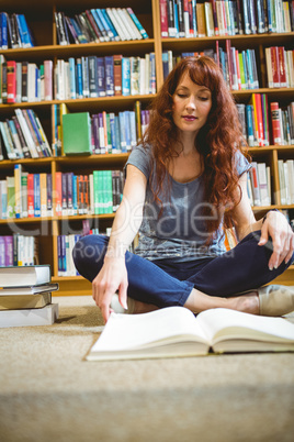 Mature student reading book in library