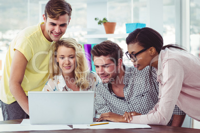 Creative business team working on a laptop together