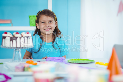 Smiling kid beside birthday cake