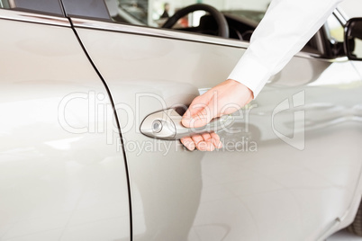 Man holding a car door handles