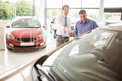 Salesman showing somethings to a man