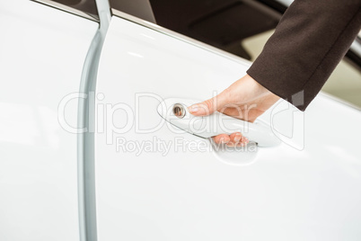 Saleswoman holding a car handles