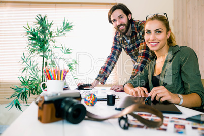 Creative team working at desk with laptop